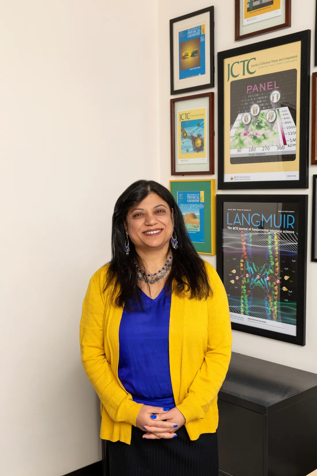 Professor Shikha Nangia standing and smiling.