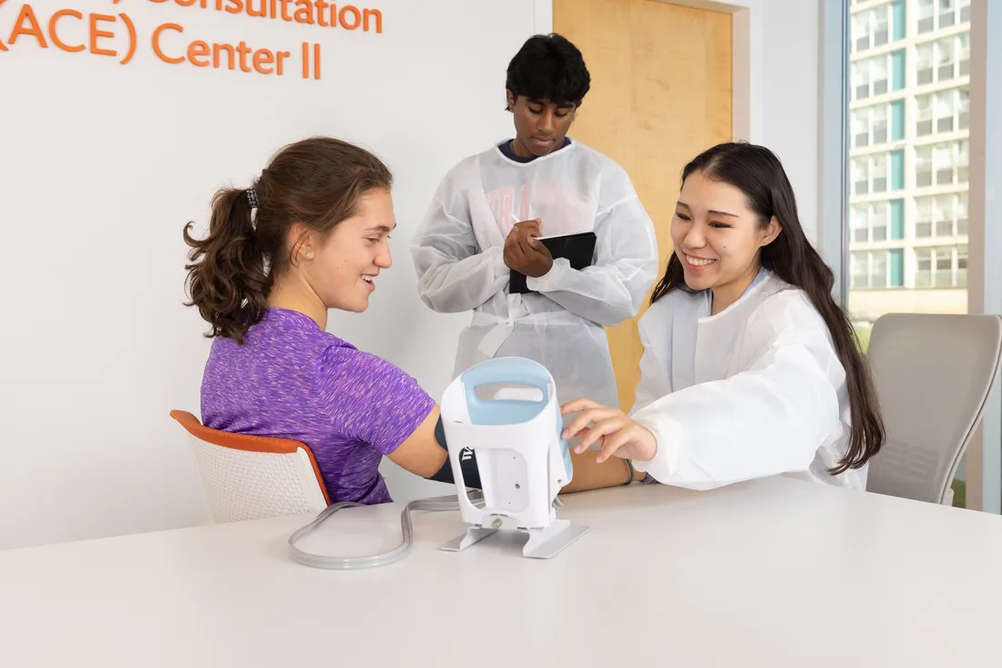 Three students work together in Falk lab.