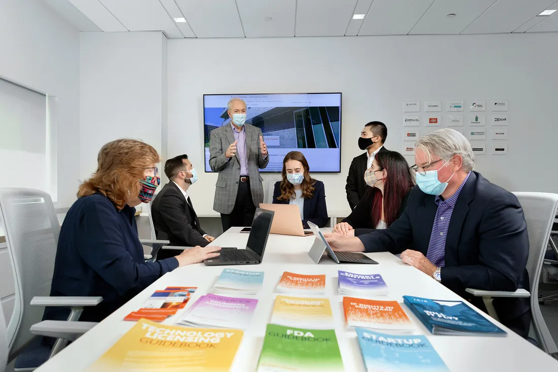 People sitting at table and working together at the Innovation Law Center.