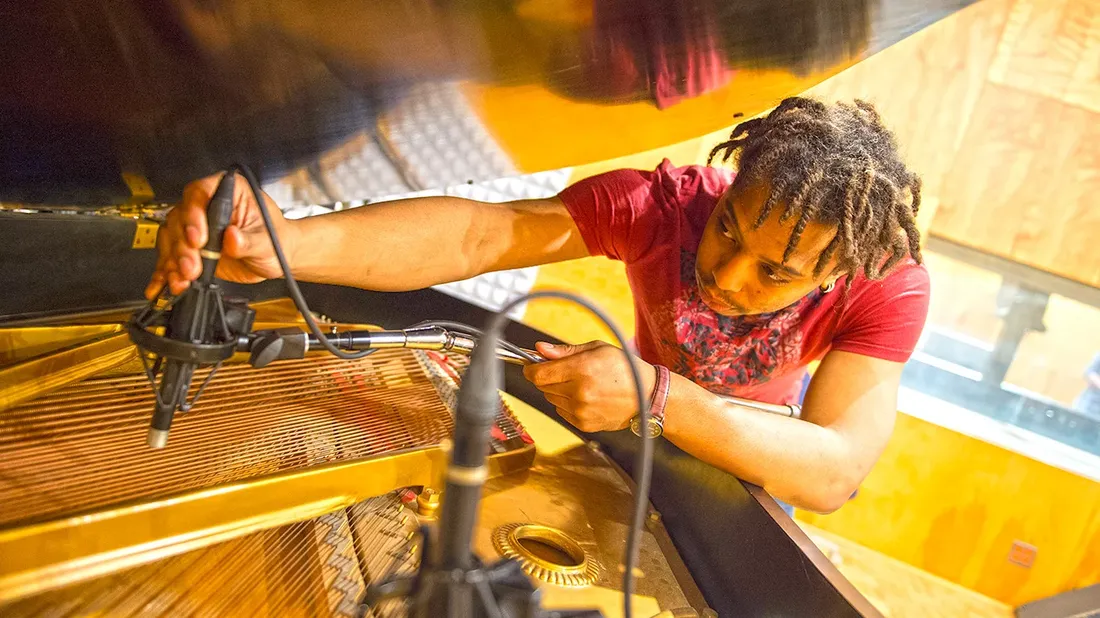 Student working on tech equipment.
