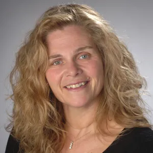 Carrie McDonald smiling in a black shirt.