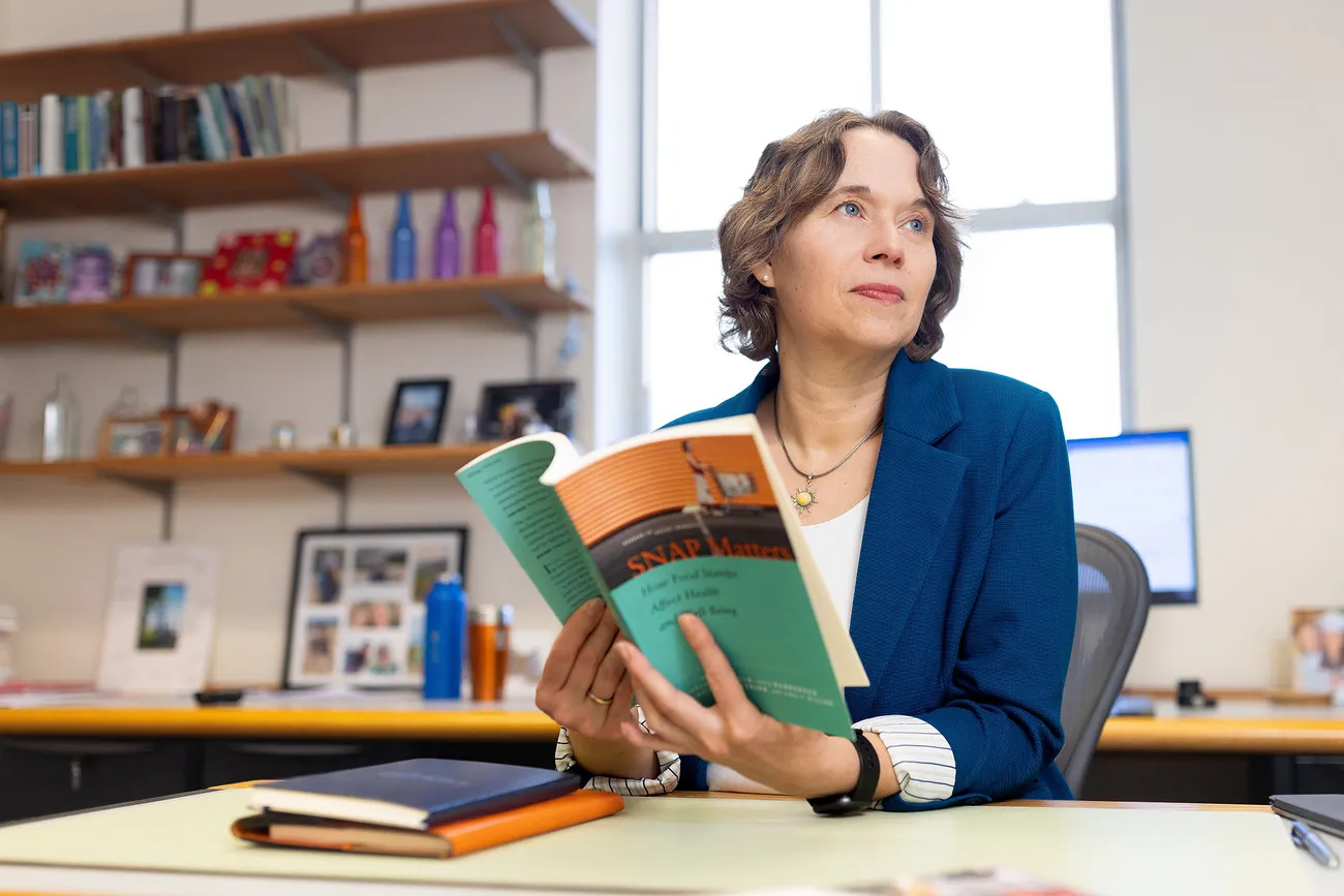 Professor reading a book and staring in the distance