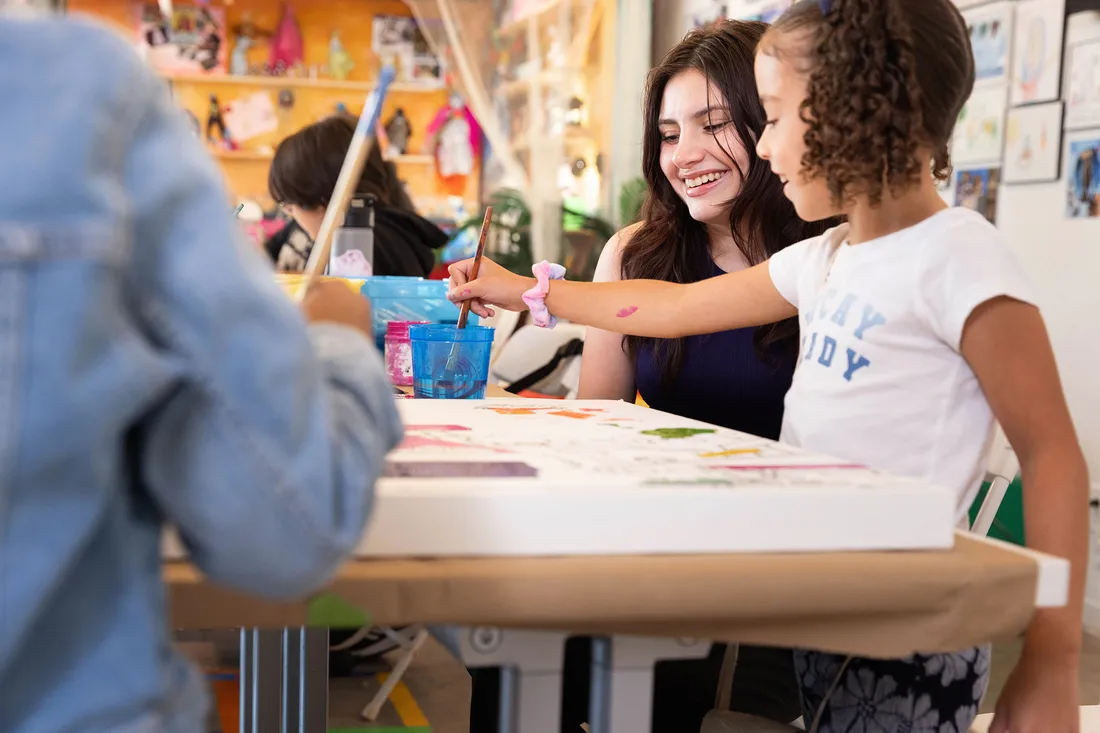 Student teacher teaching children in a classroom.