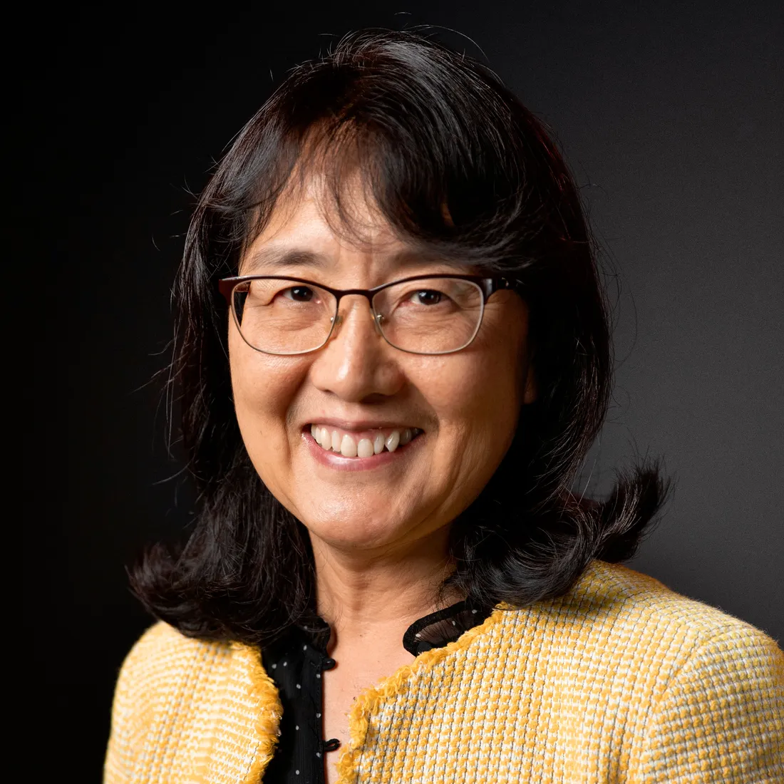 Judy Teng in a lime green blazer.