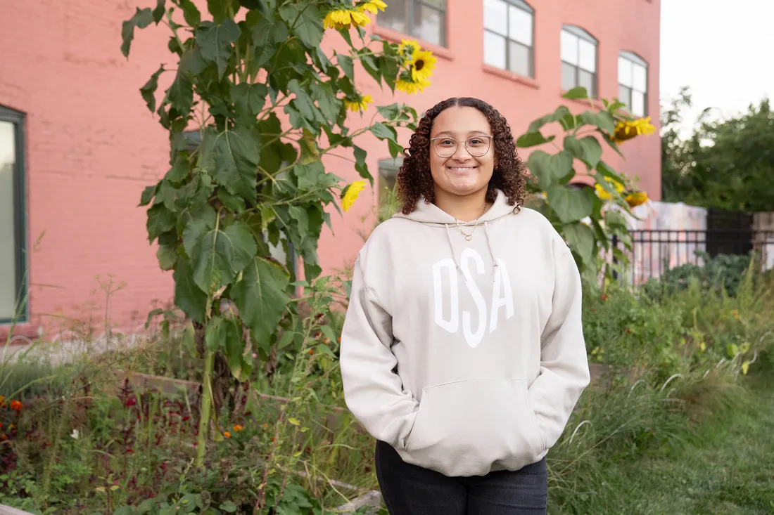Person standing in community garden.