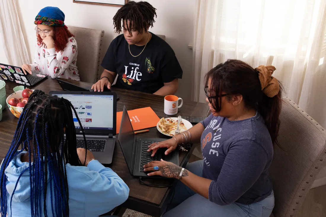 Ashlee Haste working with her kids at home.