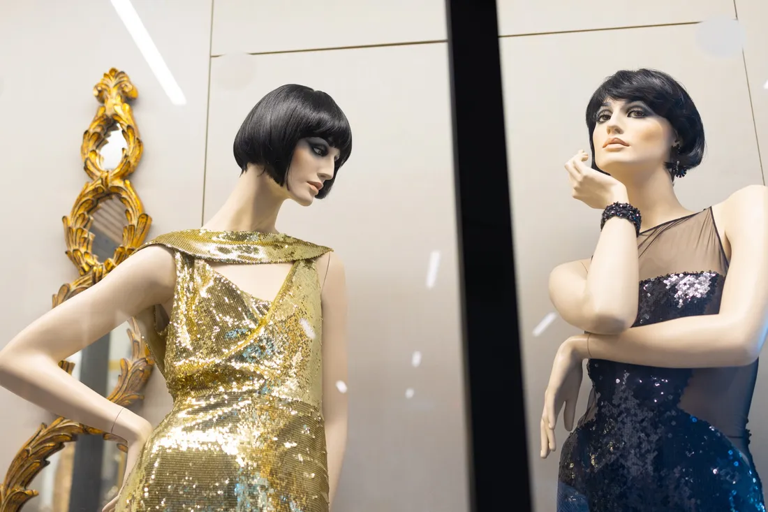 Mannequins wearing sparkly dresses that make up the Sue Anne Genet Costume Collection.