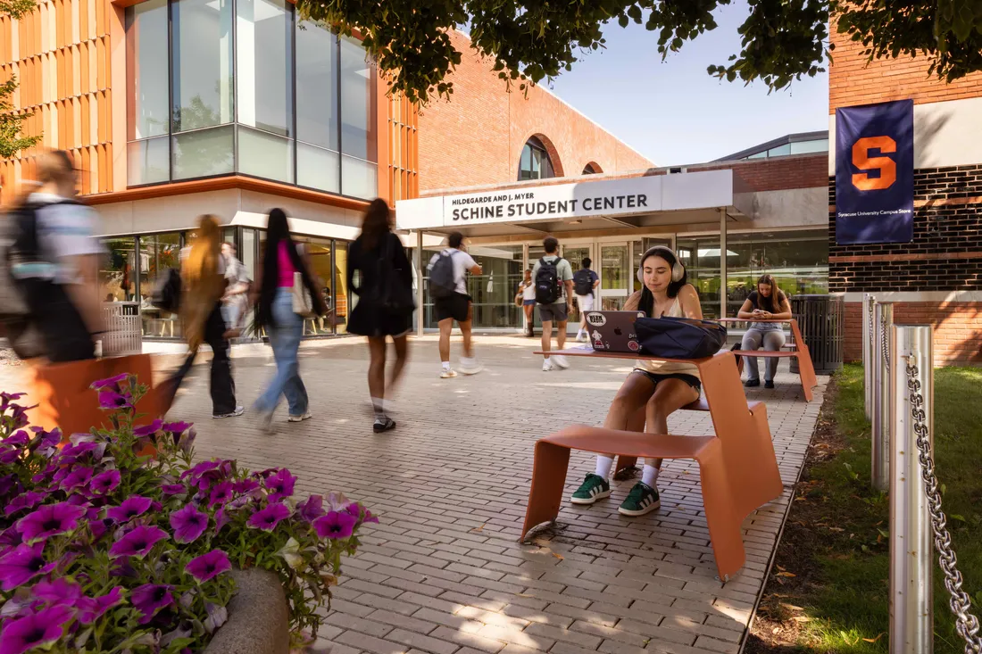 Students walking outside Schine Student Center during welcome week 2024.