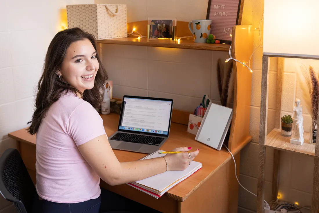 A student sitting in Sadler Dorm.