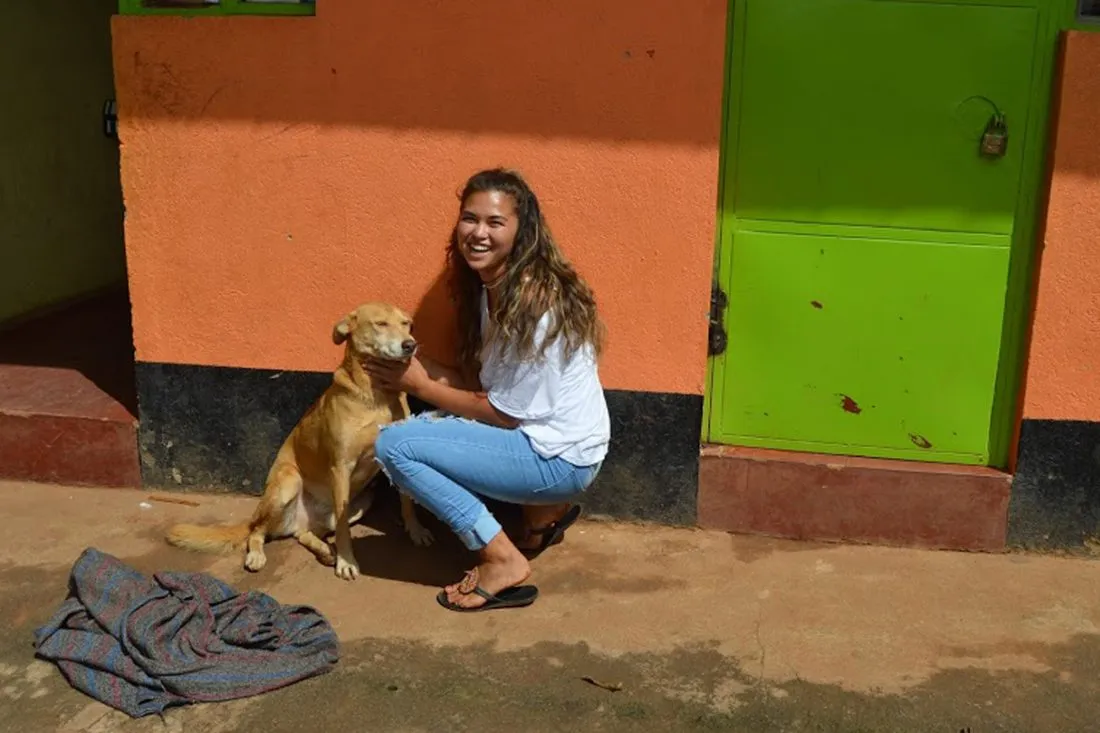 Shaylah Nichols poses with a dog in Uganda.