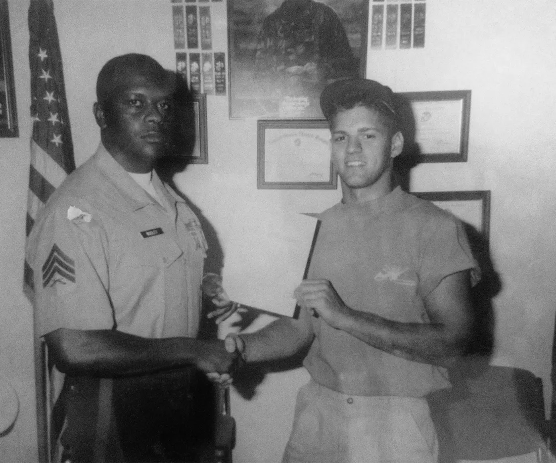 An old photo of Brian Mixon shaking Marine Corps officer's hand as they pose for a photo.