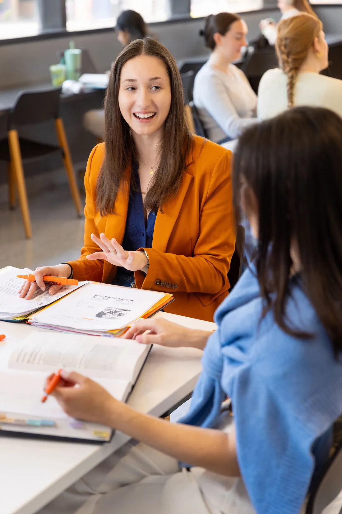 Two students having a conversation while studying.