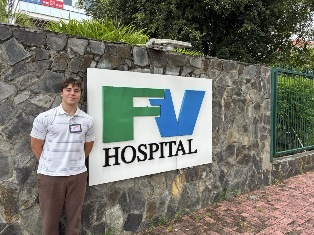 Hank Arditti '29 standing outside of FV International Hospital in Vietnam.