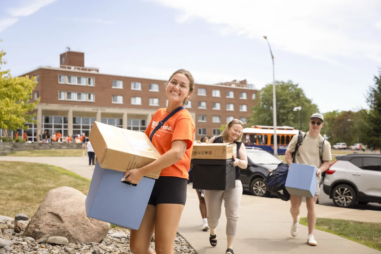 A member of the goon squad helping students move in during Welcome Week.