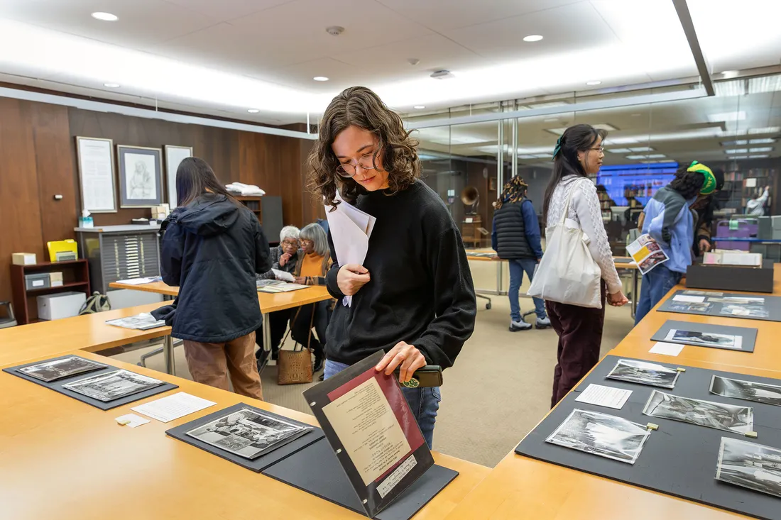 People looking at photo albums on tables.
