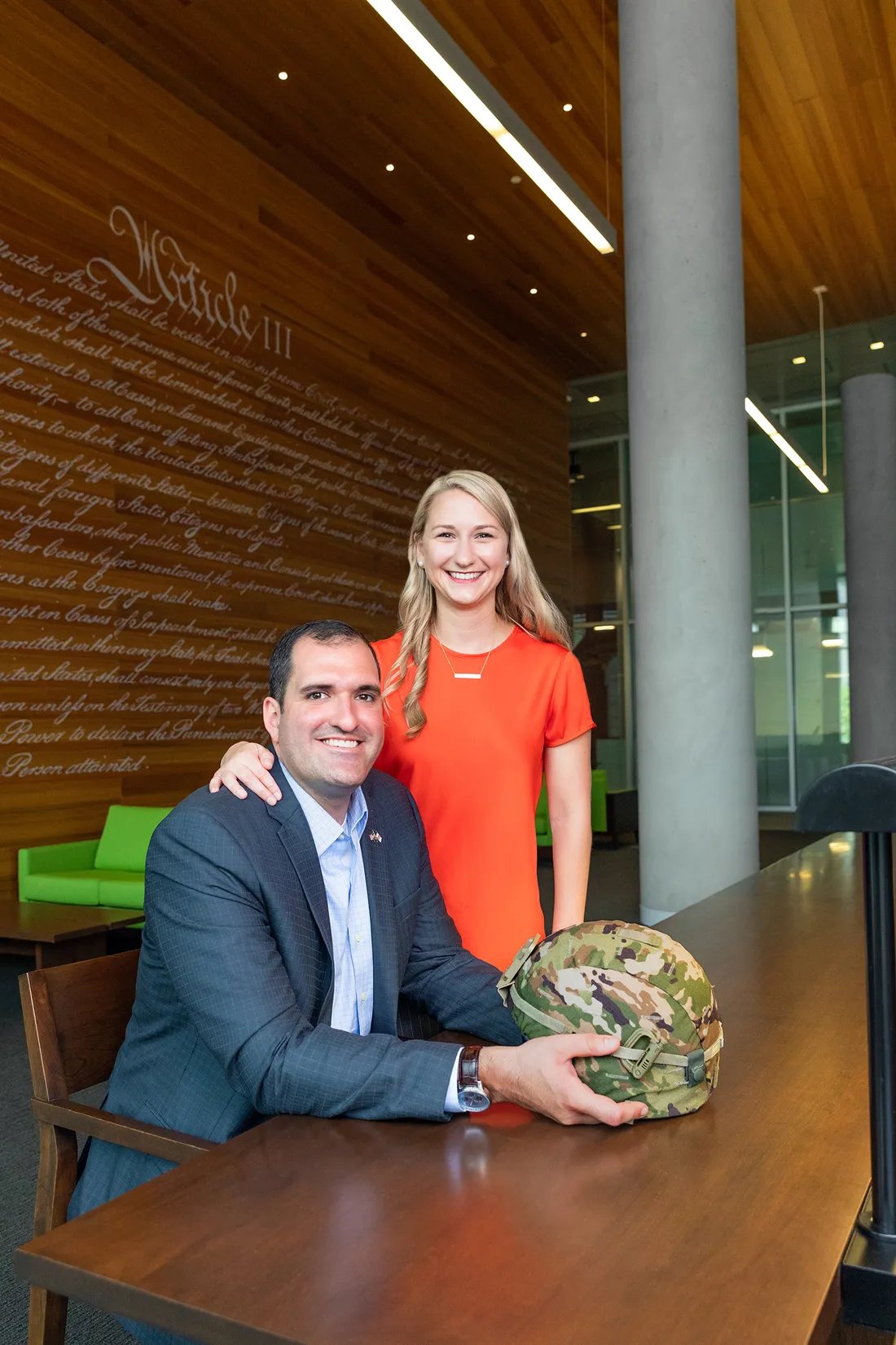 Ryan and Vanessa Marquette pose for picture at study table in Dineen Hall