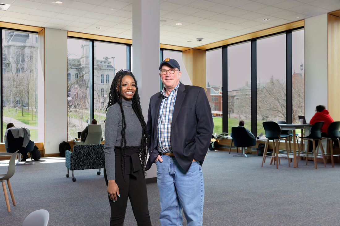 Ashanti Hunter ’22  and Thomas Bull G’90 standing together.