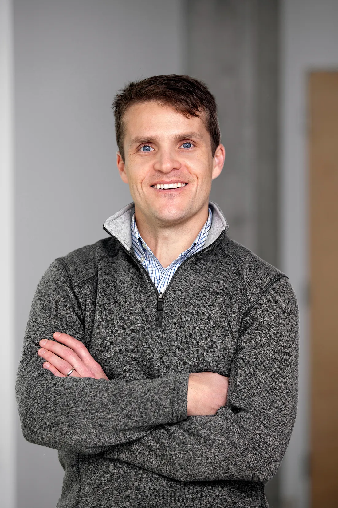 Portrait of Jonathan French, smiling with his arms crossed over his chest.