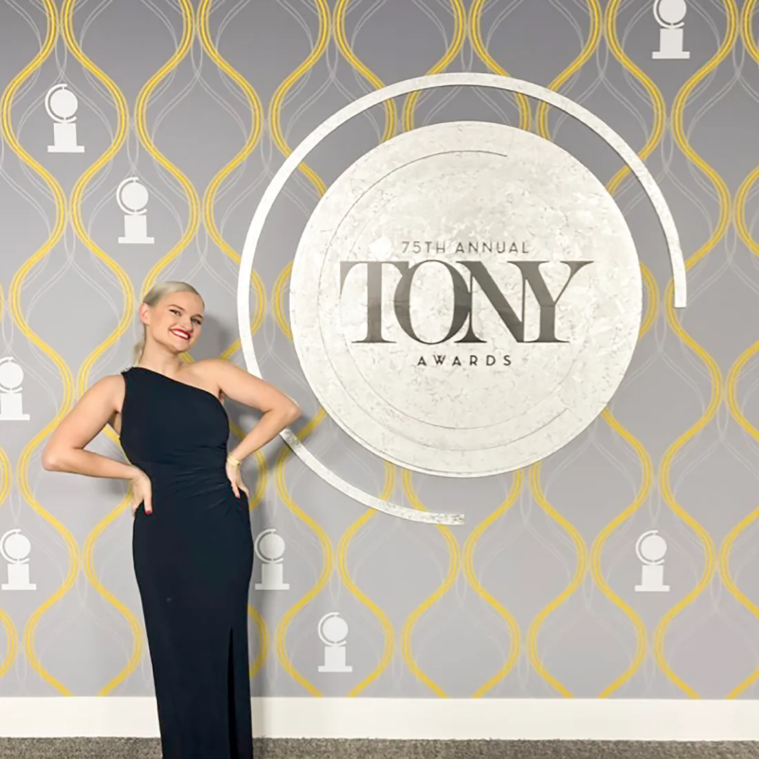 Actress standing in front of a Tony's sign.