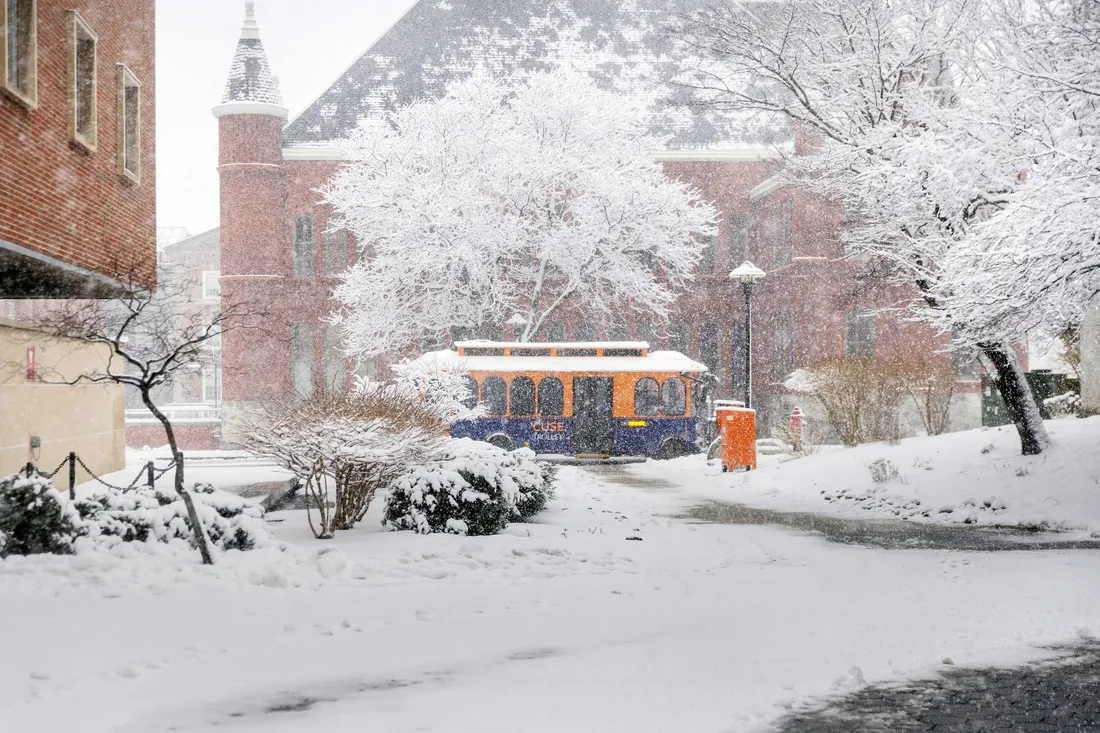 A campus trolley bus in the snow on campus.
