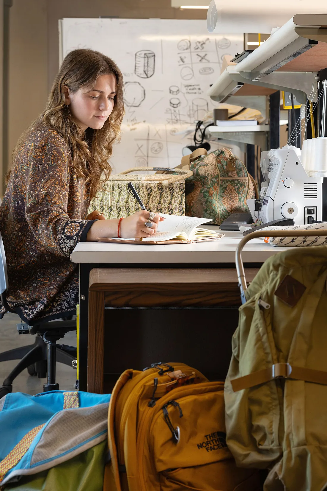Student sketching at a desk.