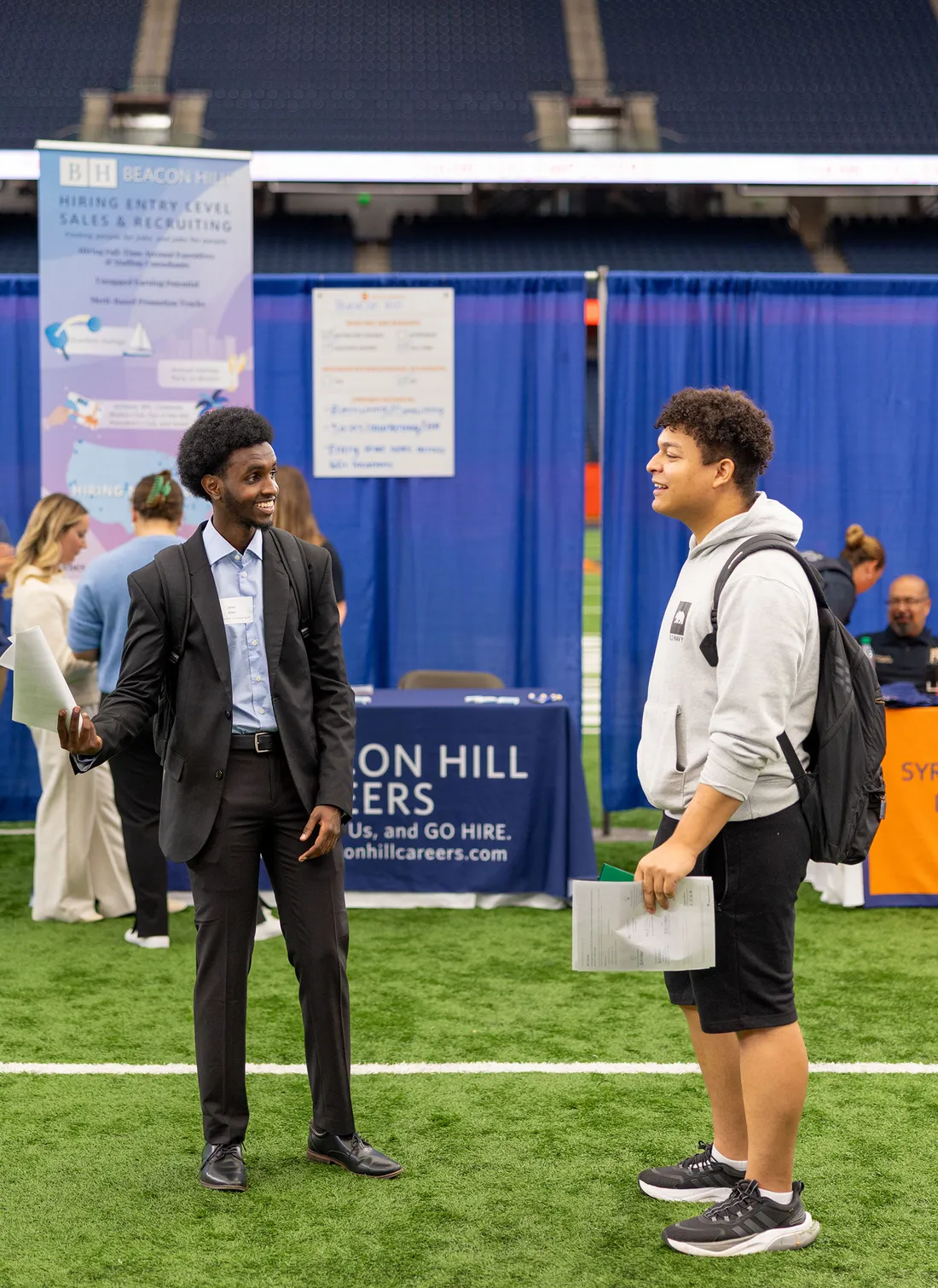 Two people talking at a career fair.