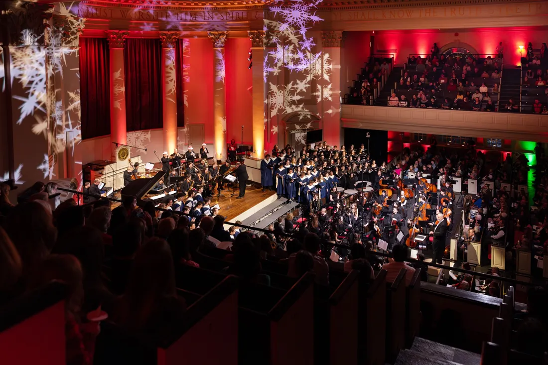 People singing in a choir in front of an audience.