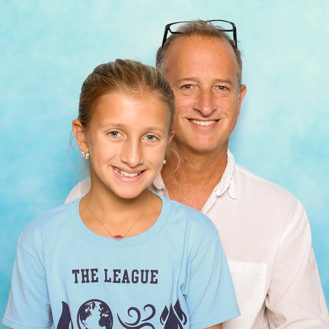 Actor posing with little girl on his lap.