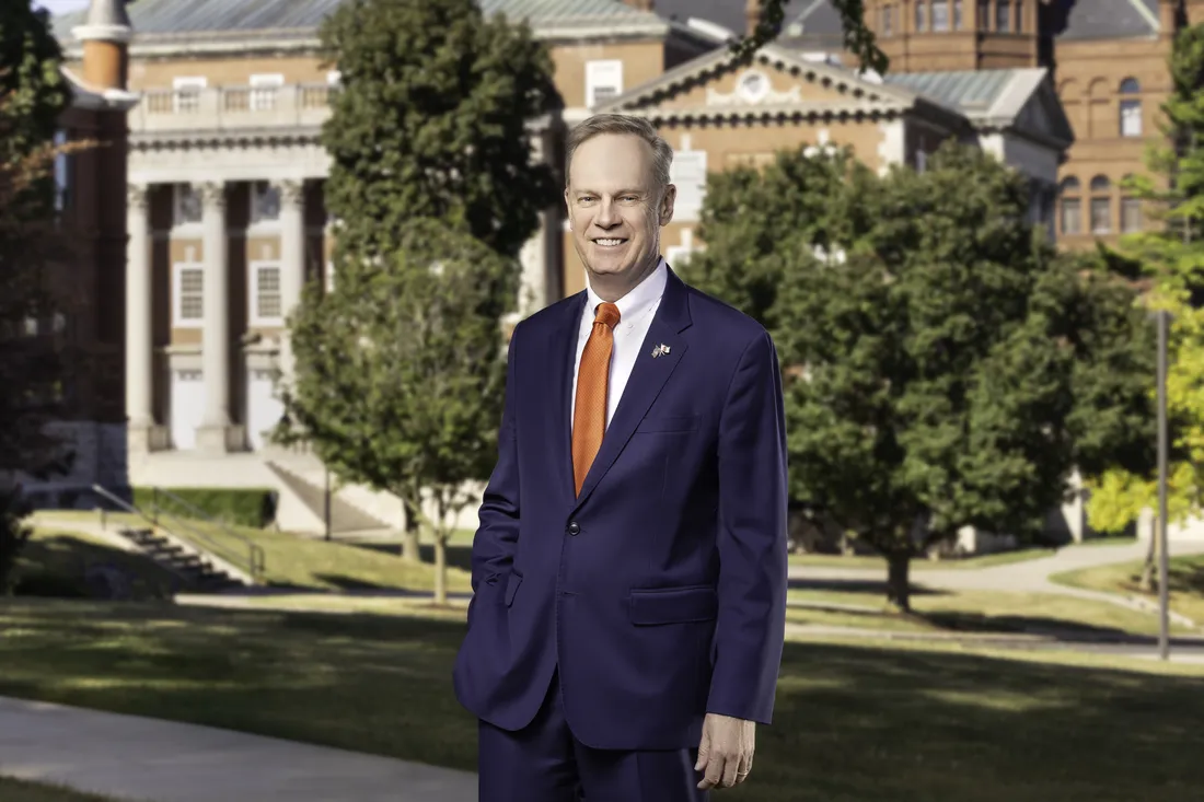 Chancellor Kent Syverud stands in front of Syracuse University campus.