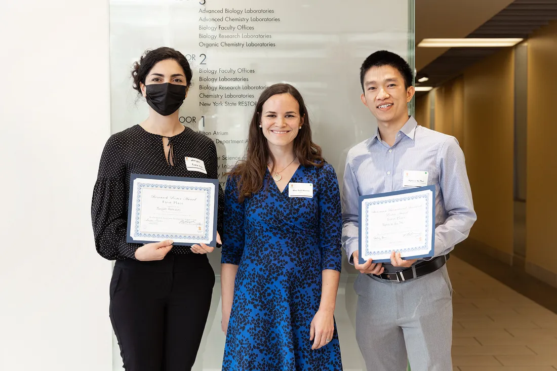 Portrait of Mary Beth Monroe and two students holding their certificates.