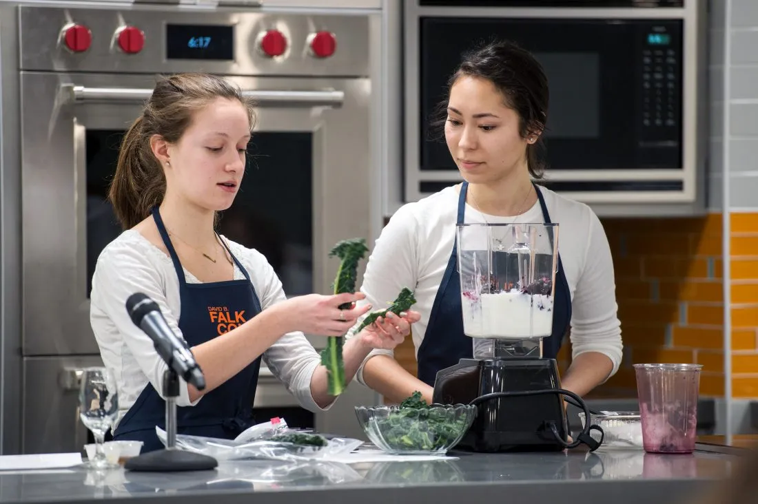 Two students in classroom kitchen.
