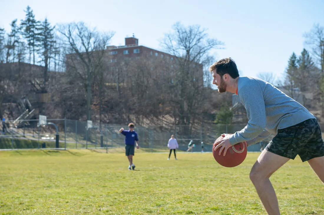 Student holding a kickball.