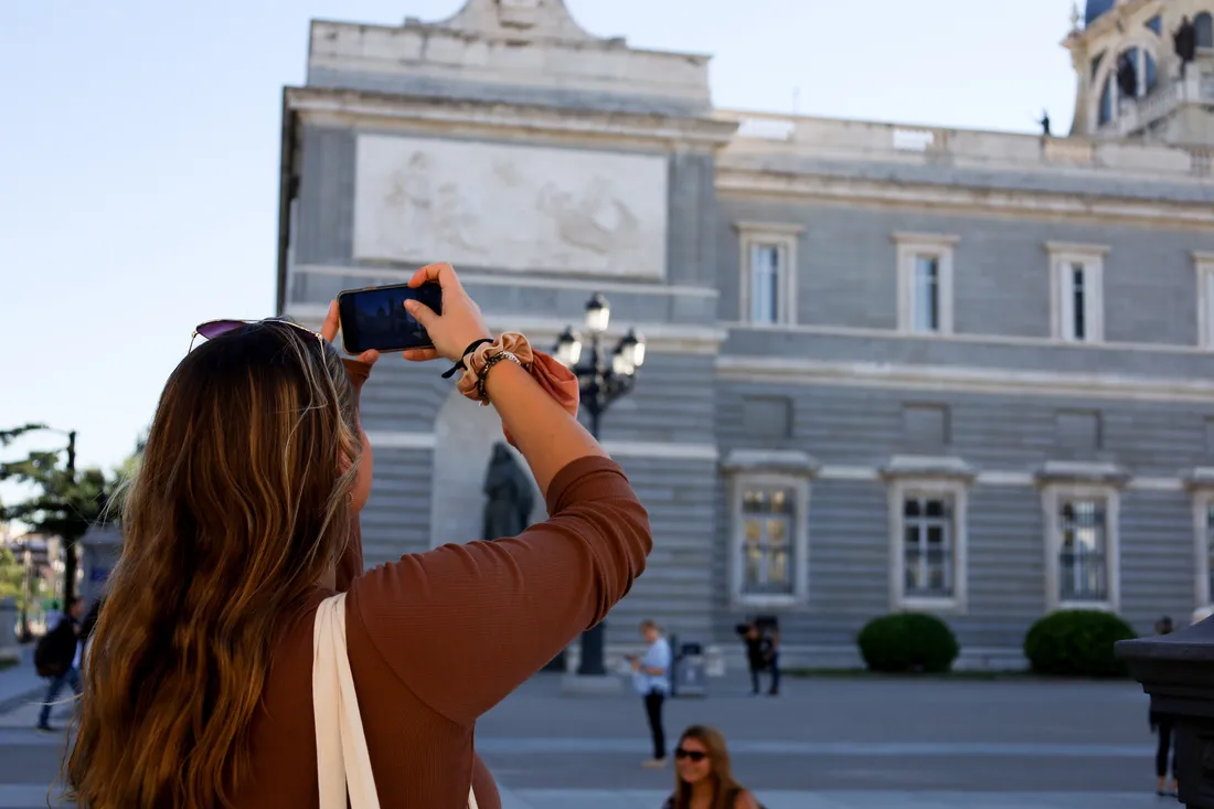 A student taking a photo on a walking tour in Madrid.