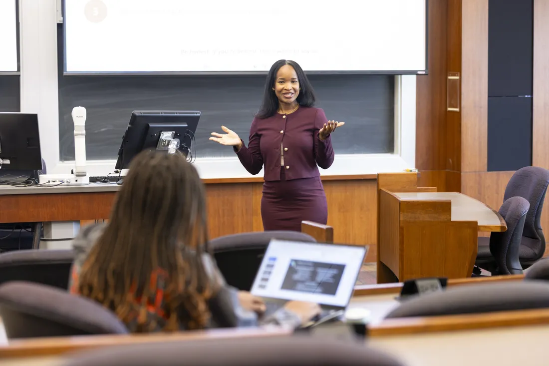 Professor standing and speaking to students.