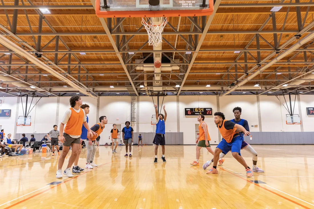 A group of people playing basketball.