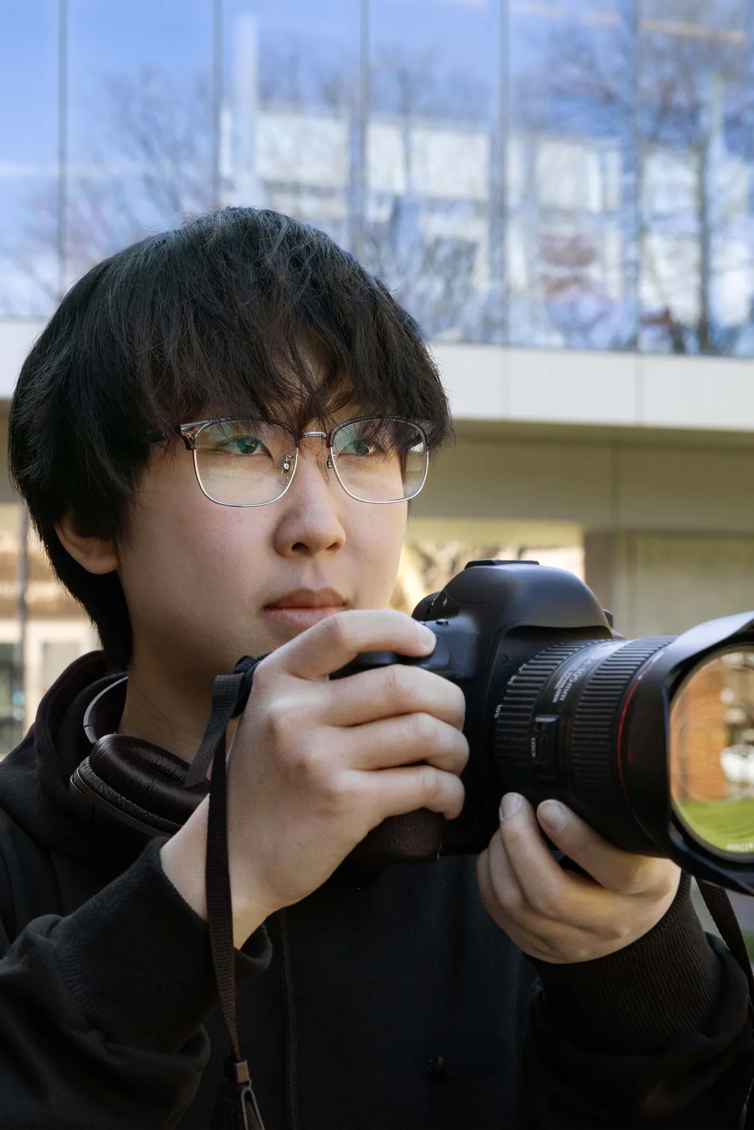 Graduate student Jiaxin Zhao looking at the photography he shot on his camera.