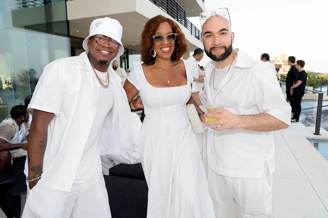 People wearing all white and posting rogether for a small group picture.