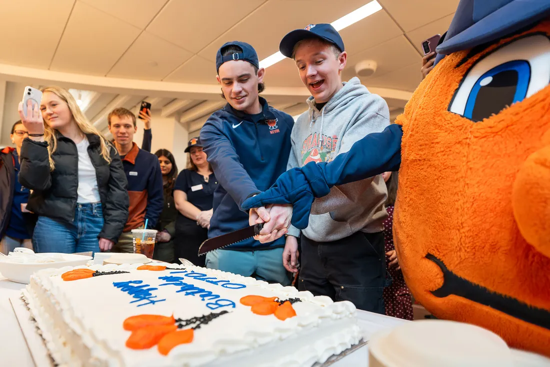 Otto and friends cutting a cake.