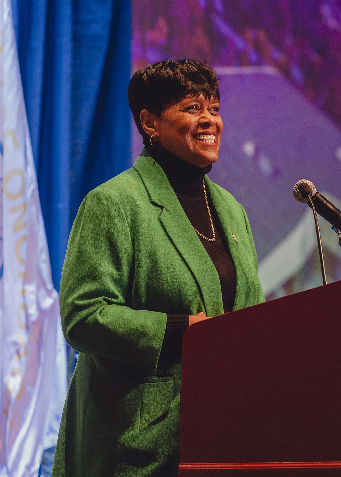 Sharon Owens standing at a podium and talking.