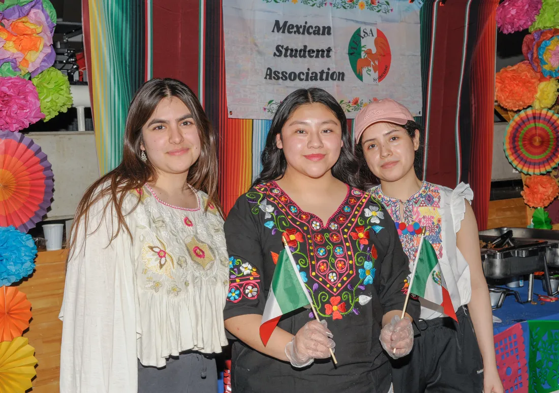 Three people standing together.