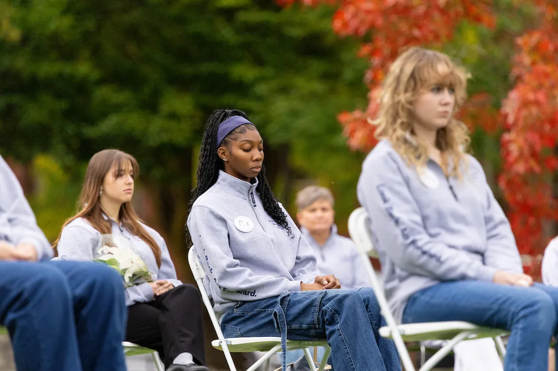 Students sitting in chairs at the sitting in solidarity ceremony.