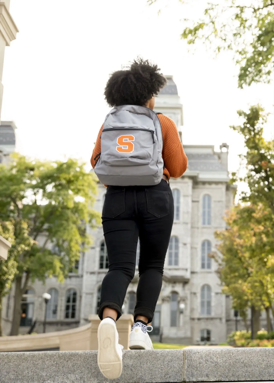 Student walking outside up to the Hall of Languages.