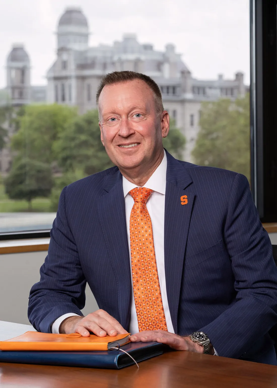 Headshot of Chancellor Micheal Haynie sitting at a table with a notebook.