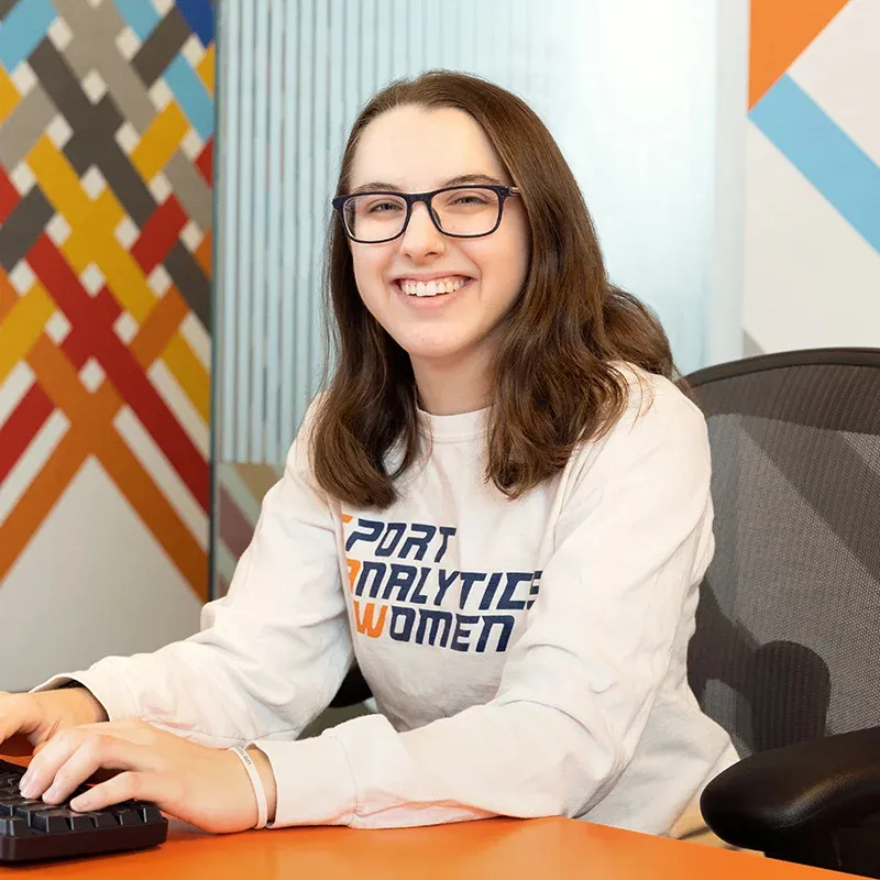 Alison Gilmore sitting at a desk and smiling.