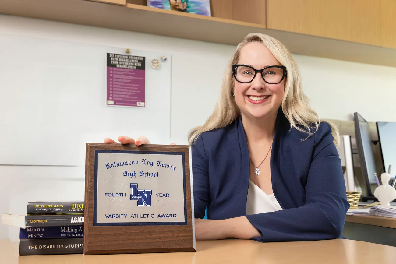 Mat Macfarlane at her desk with an award.