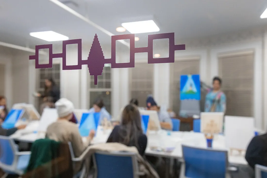 Classroom of studnets with a native symbol on window.