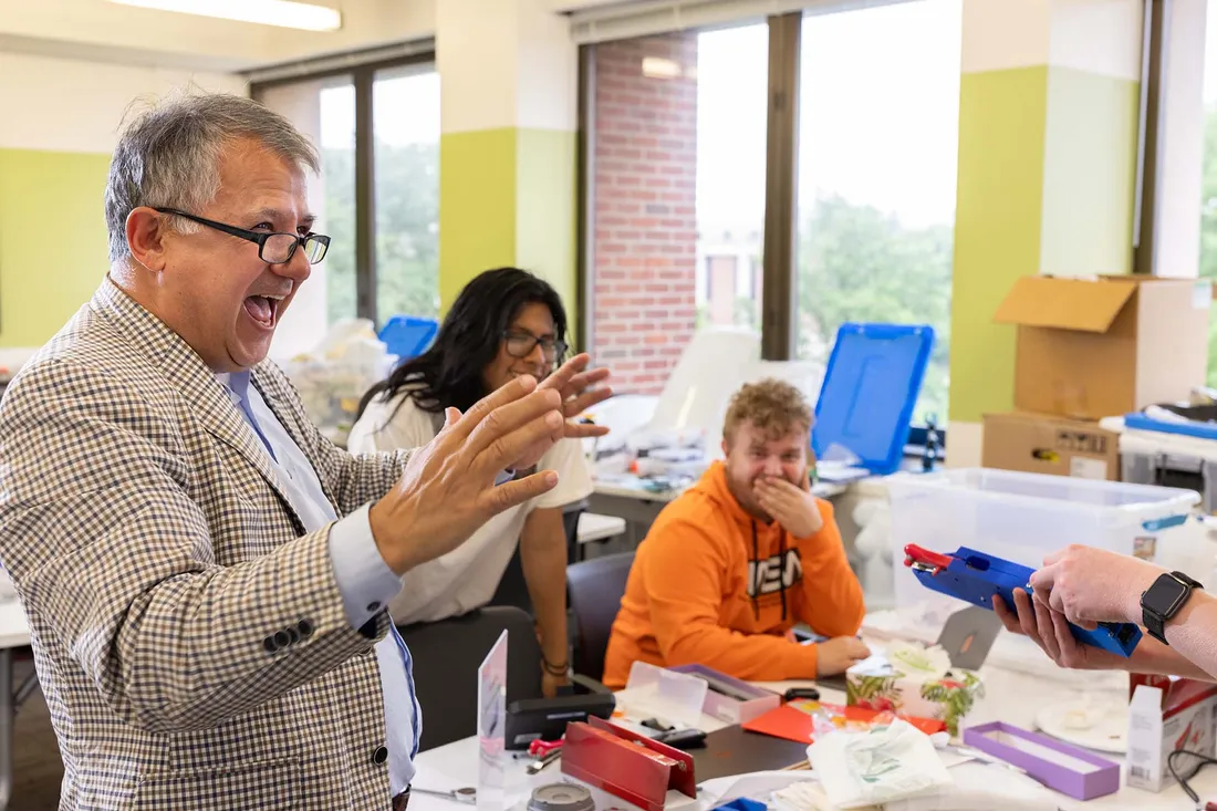 Professor speaks enthusiastically to classroom.