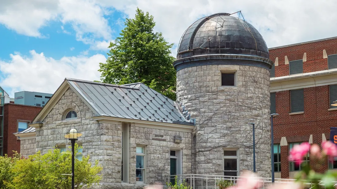 A shot of Holden Observatory with flowers in the foreground.