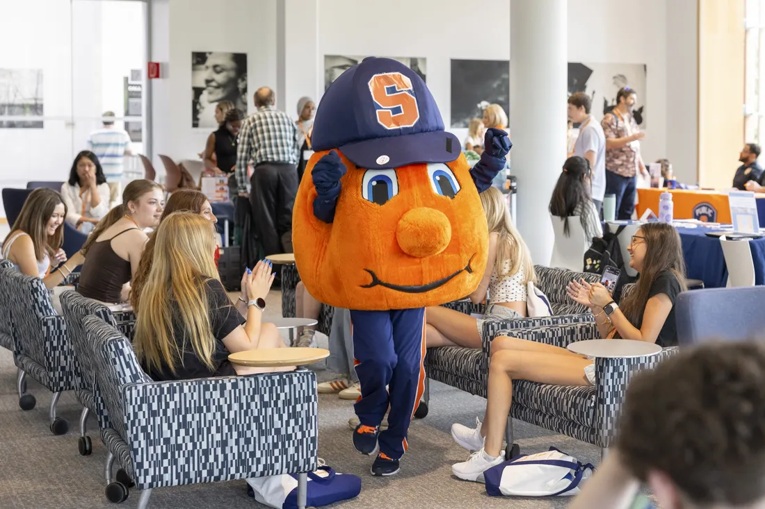 Otto the Orange greeting new students during orientation.