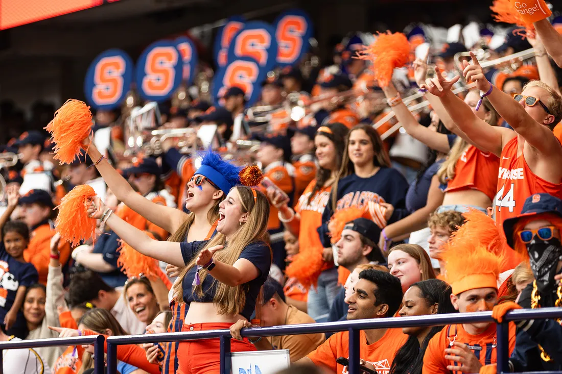Crowd of fans cheering at a game in the dome.